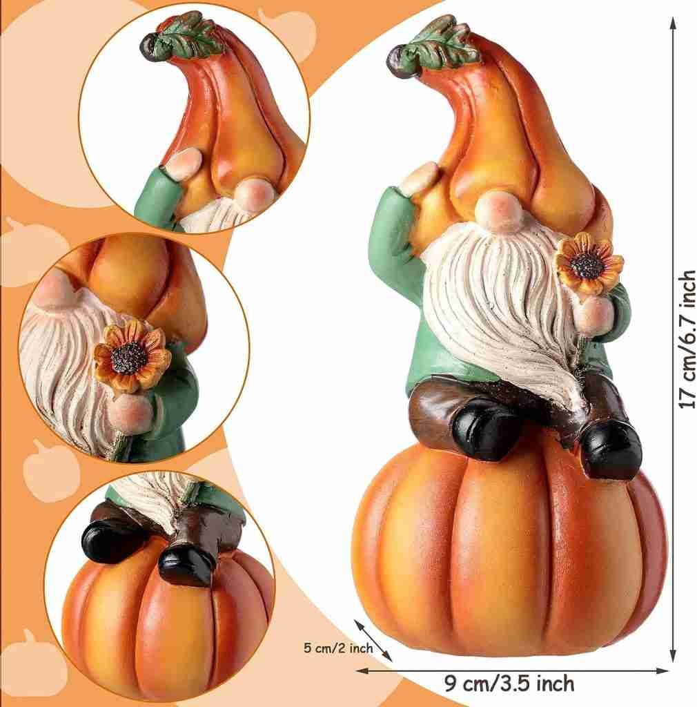 A ceramic gnome figurine with a pumpkin-shaped hat, holding a sunflower, sitting on an orange pumpkin. The figurine is 17 cm (6.7 inches) tall and 9 cm (3.5 inches) wide. Three close-up images show details of the hat, sunflower, and feet.