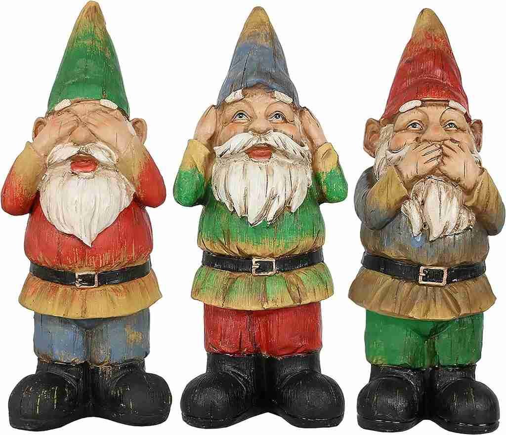 Three garden gnomes in "see no evil, hear no evil, speak no evil" poses with green, blue, and red hats and colorful clothing.