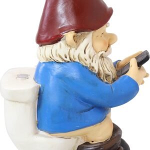 A garden gnome figurine wearing a red hat, blue shirt, and black boots, sitting on a toilet and holding a smartphone.