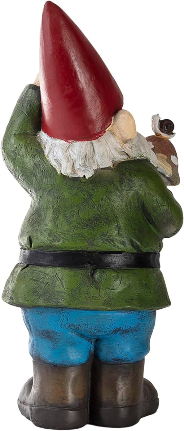 Back view of a garden gnome in a green shirt, blue pants, and red hat holding a small bird.