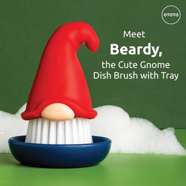 A gnome-shaped dish brush with a red hat and white bristles sits in a blue tray. Text reads, "Meet Beardy, the Cute Gnome Dish Brush with Tray" with the OTOTO logo in the corner.